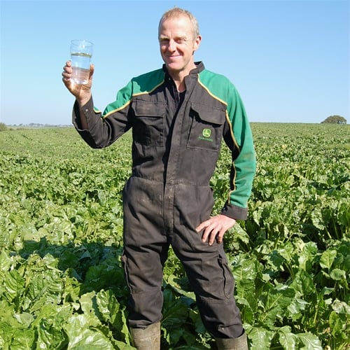 Farmer Andrew Jones raises a glass of water to Upstream Thinking